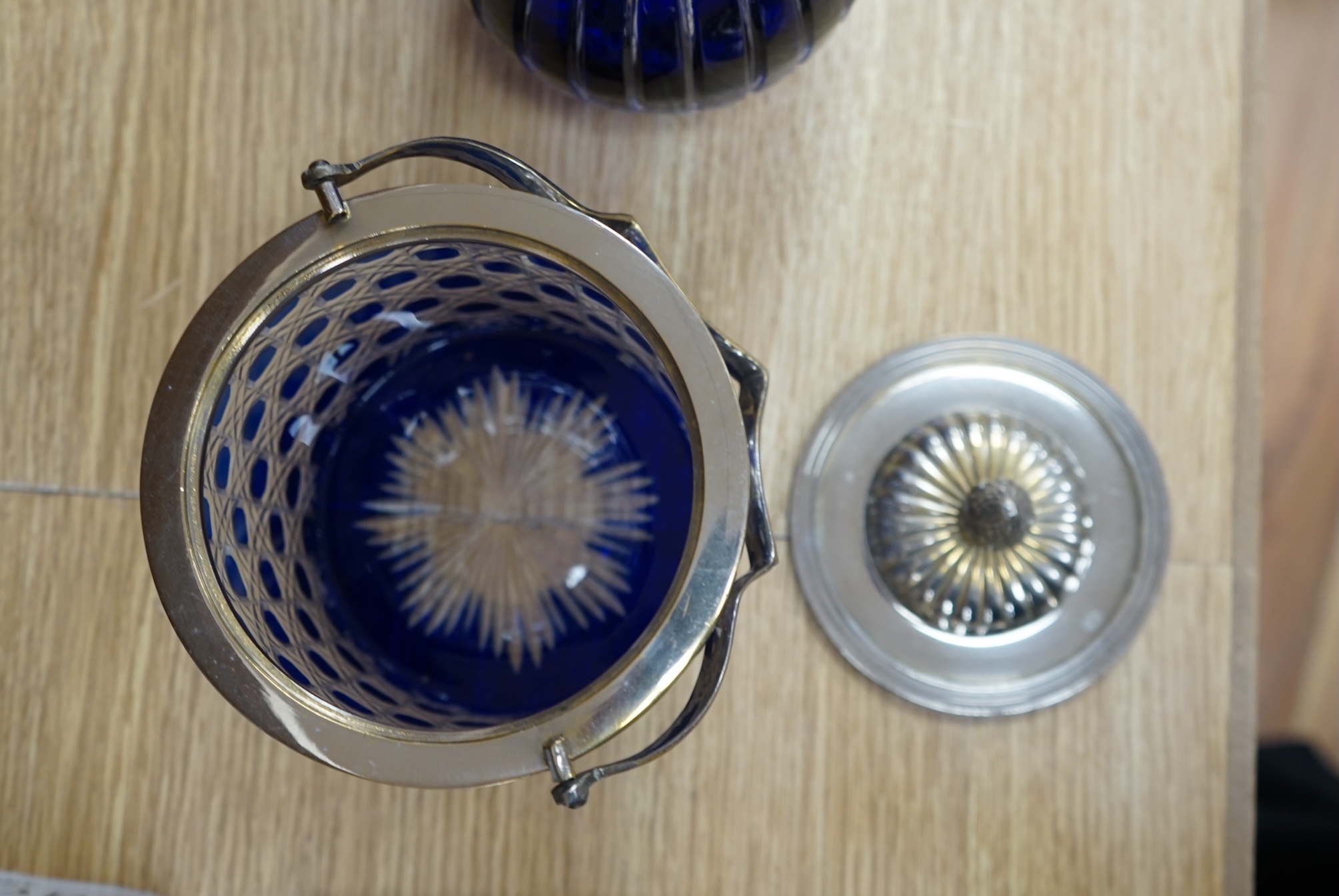 A collection of blue glassware comprising a late 18th century Bristol blue glass decanter and tear drop stopper, 30cm, a mid 19th century electroplate mounted blue glass decanter, a later Hungarian decanter and a similar